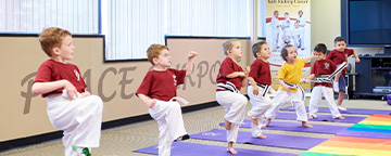 Kids in karate position in a dojo