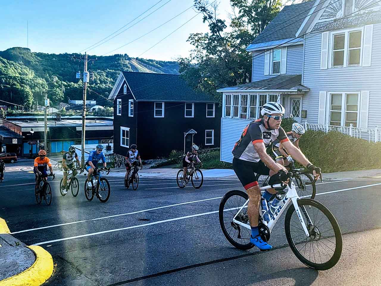 TDY cyclists ascending an uphill street in Houghton, MI.