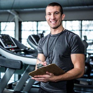 Nutrition coach holding a clipboard and smiling.