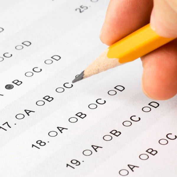 Pencil held above a multiple-choice test.