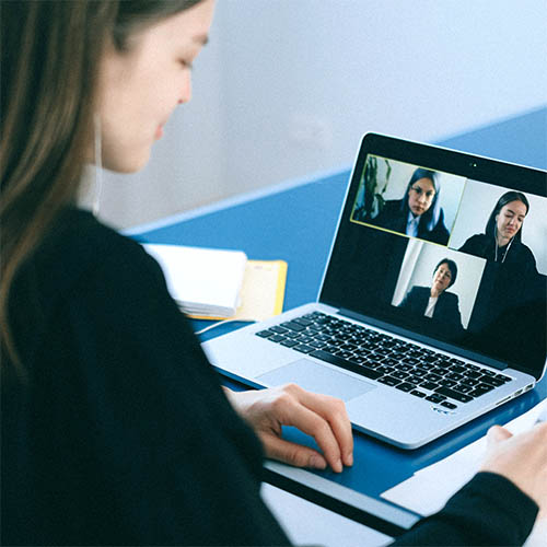 Woman participating in an online meeting.