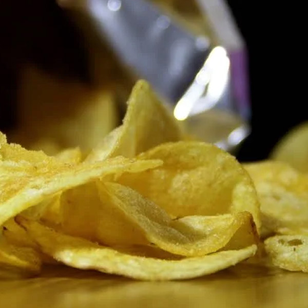 Chips spilling from a bag onto a table.