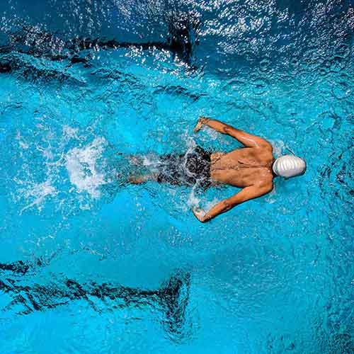 Man swimming in a pool.